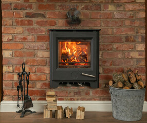 In wall log burner with a roaring fire