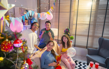Portrait group of Asian friends in christmas party together at home