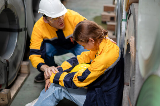 tired female worker feeling sick after stressed work in manufacturing factory, exhausted woman technician has problem working overload, male foreman support consoling and encorage at metal warehouse
