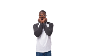 young surprised well-groomed african man with a short haircut dressed in a sweatshirt on a studio background with copy space
