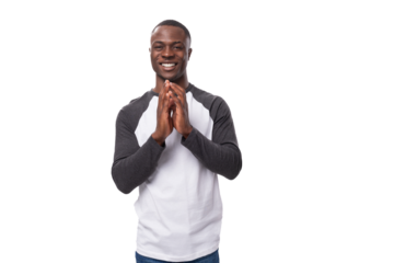 young positive african man dressed in a spring jacket folded his hands together and hopes for the best