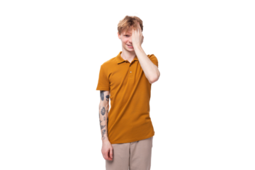 young handsome red-haired man with a haircut and a tattoo on his arm against the background of copy space