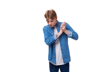 young well-groomed caucasian red-haired man in a denim shirt looks stylish