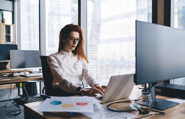 Serious businesswoman working on laptop