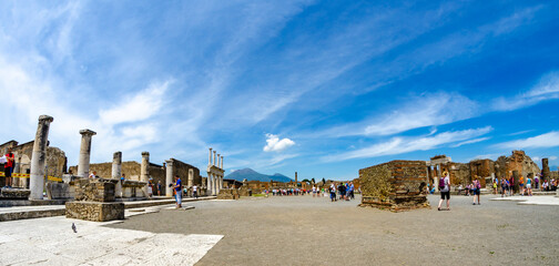 Pompeii, Italy - May 30, 2015: tourists walking in the Forum of the ancient ruins at Pompeii, that was buried by the eruption of the volcano Vesuvius in Italy