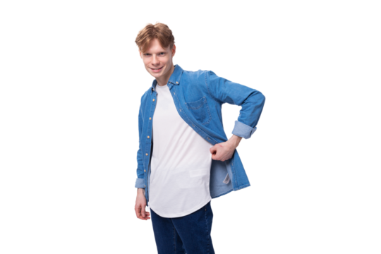 young confident european guy with golden hair dressed in a blue denim shirt over a white t-shirt with a mockup. advertising concept
