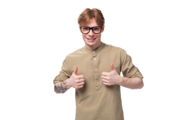 a young successful red-haired caucasian guy dressed in a khaki short-sleeve shirt looks at the camera and shows confidence