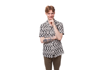 a young smart guy with red hair and a tattoo on his arms is dressed in a short-sleeve shirt thinking about the development of an idea