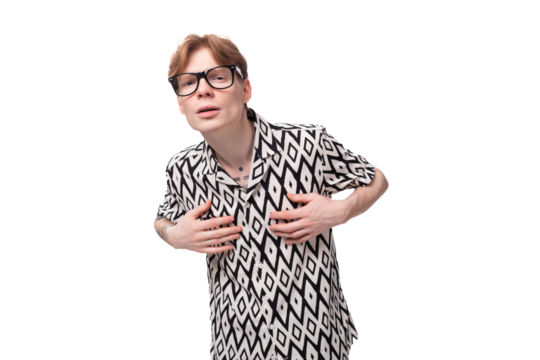 a young red-haired guy in glasses dressed in a summer shirt is experiencing discomfort with poor eyesight