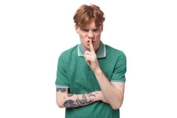 young emotional caucasian man with red hair dressed in a green t-shirt keeps a secret