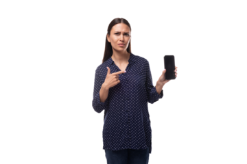 young cheerful cute caucasian brunette lady dressed in dark blue blouse holding smartphone with mockup