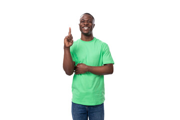 young handsome african man in light green t-shirt and jeans tells interesting news