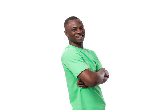 portrait of young successful handsome american man in green t-shirt and jeans