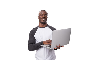 young african man working remotely in the field of IT and using a laptop