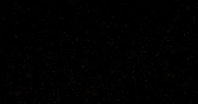 Clouds of golden thin dots random flying on black background. Golden background for holiday greetings.