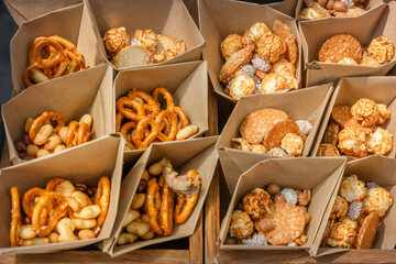 Cookies and snacks are packaged in kraft paper bags for street vendors. Close-up
