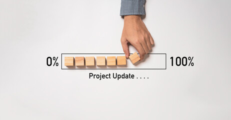 Hand arrange wooden block cube download bar from 0% to 100% for project update progress concept.