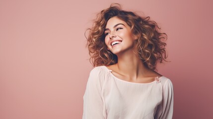 Obraz premium Portrait of a cheerful young woman wearing pink shirt standing isolated over pink background, looking at camera, posing