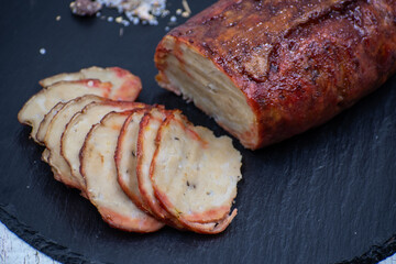Washed flour seitan, vegan glazed ham sliced on black slate stone