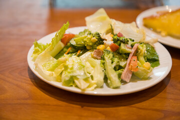 Mix of vegetables salad in a ceramic plate