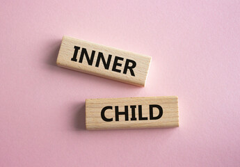 Inner Child symbol. Wooden blocks with words Inner Child. Beautiful pink background. Business and Inner Child concept. Copy space.