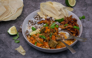 Thai vegan red curry made with seitan (plant based meat) sweet potatom rice, Along with rice and starch pancakes