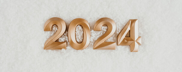 Greeting banner - happy new year with gold numbers 2024 on artificial snow white background