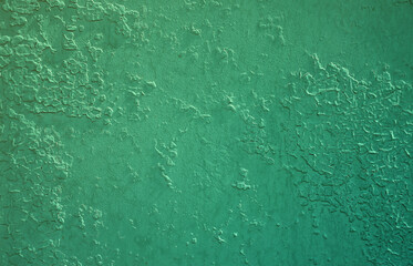 Texture of a metal wall with an old paint coating that spoils under the influence of time and weather