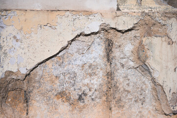 Brown stone A close up of a cement wall with cracks