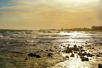 A raging sea with a view of the harbor.
