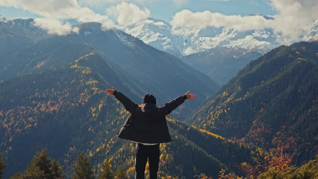 Happy tourist woman open arms into air and enjoying life and freedom on top of mountain in spring or autumn, Happy and drunk on life.