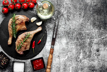 Grilled duck legs on a stone background with copy space for your text