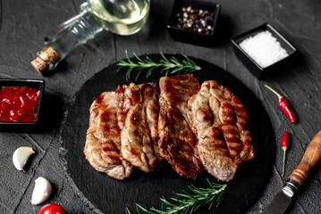 grilled pork steaks on stone background