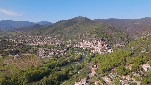 Aerial view of the typical French town named Roquebrun. A town build on a hill next to a river