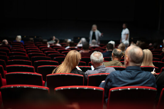 People in the cinema auditorium taking seats