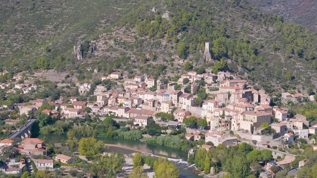 Aerial view of the typical French town named Roquebrun. A town build on a hill next to a river