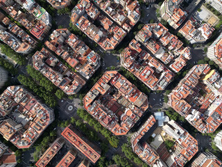 Fototapeta premium Aerial view of Barcelona Eixample residential district and Sagrada Familia Basilica at sunrise. Catalonia, Spain. Cityscape with typical urban octagon blocks