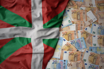 colorful waving national flag of basque country on a euro money background. finance concept