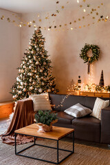 Interior of modern living room with comfortable sofa decorated with Christmas tree and gifts - 673321379