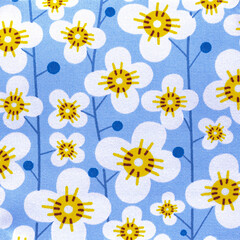 Fototapeta na wymiar Floral pattern cotton fabric design closeup in blue and white