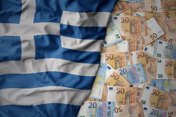 colorful waving national flag of greece on a euro money background. finance concept