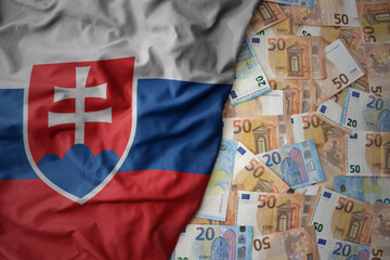 colorful waving national flag of slovakia on a euro money background. finance concept