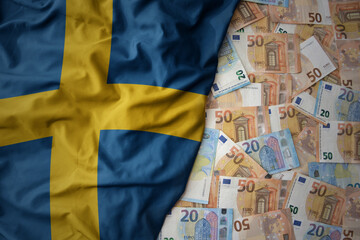 colorful waving national flag of sweden on a euro money background. finance concept