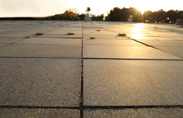 Street tiles.Cobbles at sunset. Sunlight on Cobble Stones against tall houses. sun light and sun...