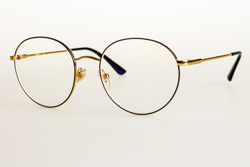 Women's round shape glasses with thin metal frame in gold color, fashion glasses for everyday wear, selective focus