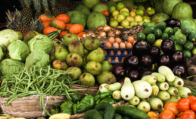 Stalls with seasonal fruits and vegetables on a market in Cotonou