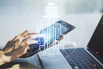 Double exposure of creative light bulb hologram with chip and finger clicks on a digital tablet on background, idea and brainstorming concept