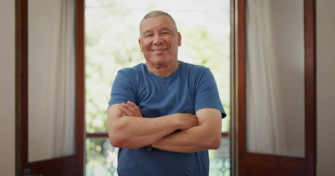 Face, smile and senior man with arms crossed in home, living room and apartment for retirement. Portrait, happy elderly person and confidence in house, health and wellness of pensioner in Mexico