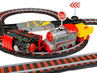 toy railroad with battery-powered steam locomotives and railway track, isolated on white background