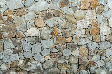Stone wall texture with cracks and small holes attracts tourists attention with durability and stability over years